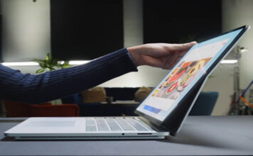 Woman opening Microsoft Surface premium Windows laptop.