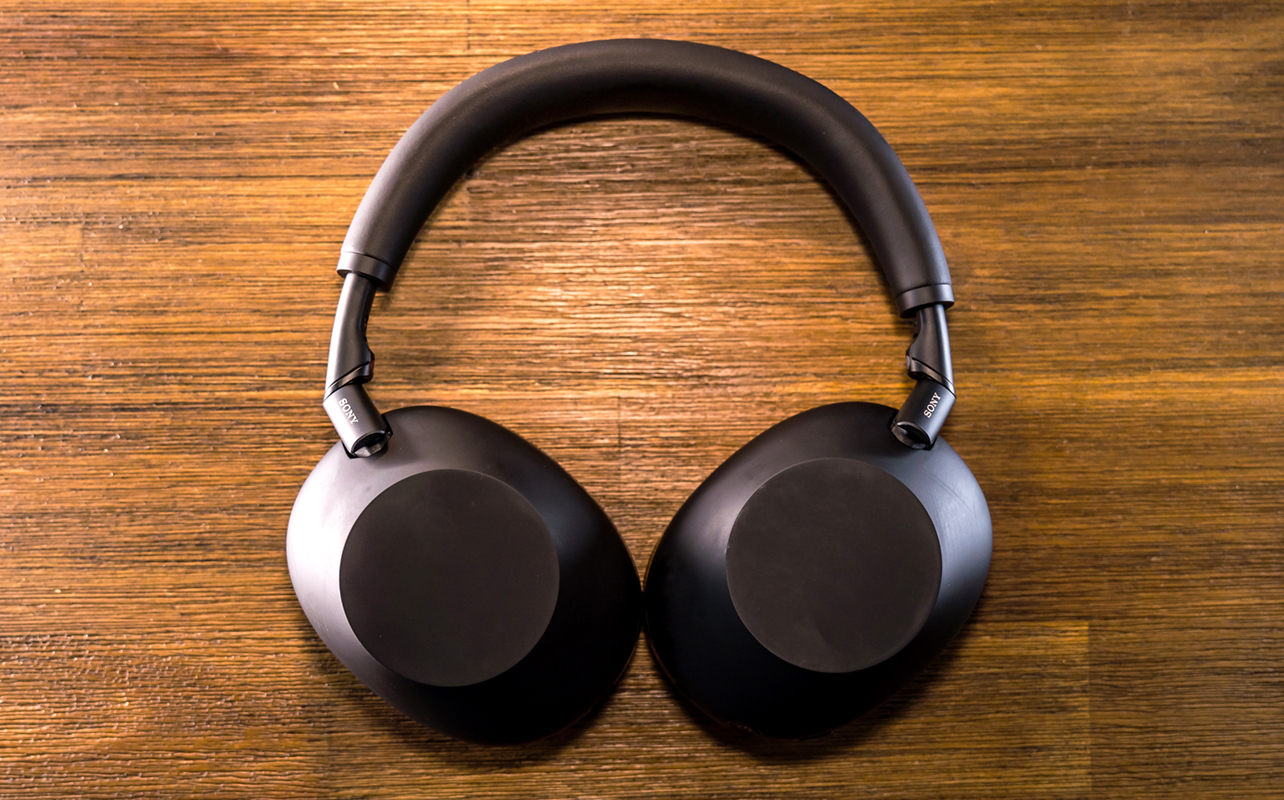 Sony WH-1000XM6 headphones in black folded flat on table.