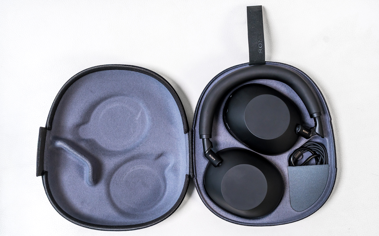 Sony WH-1000XM6 headphones laying flat in case.