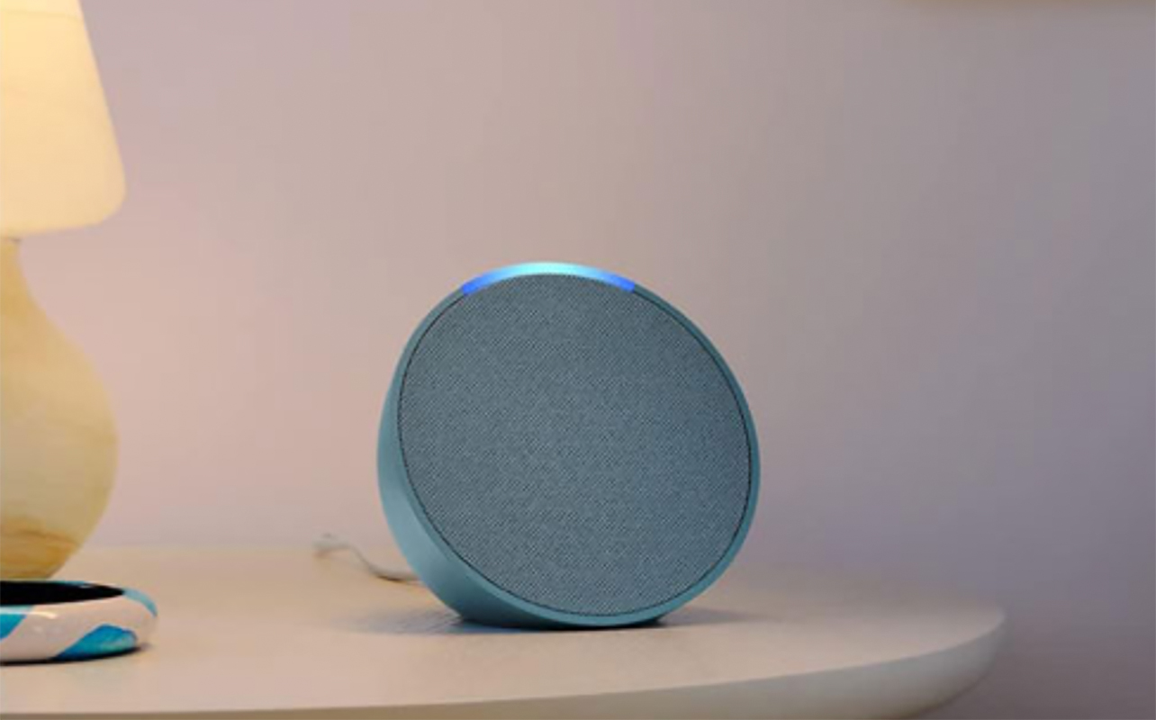Amazon Echo Pop on a side table.