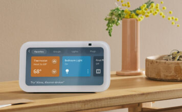 An Amazon Echo Show 5 on a side table showing smart home controls.