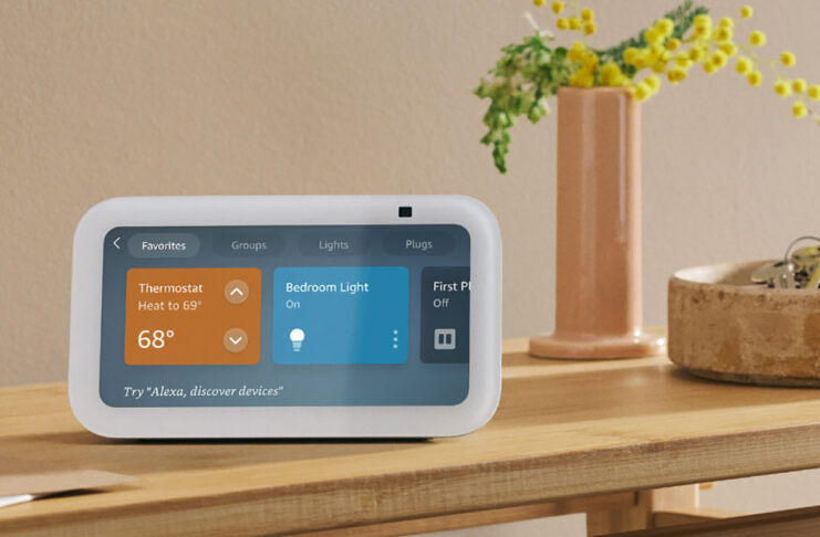 An Amazon Echo Show 5 on a side table showing smart home controls.