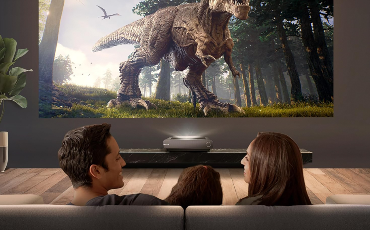 A family watching TV using the Hisense TriChroma ultra-short throw projector.