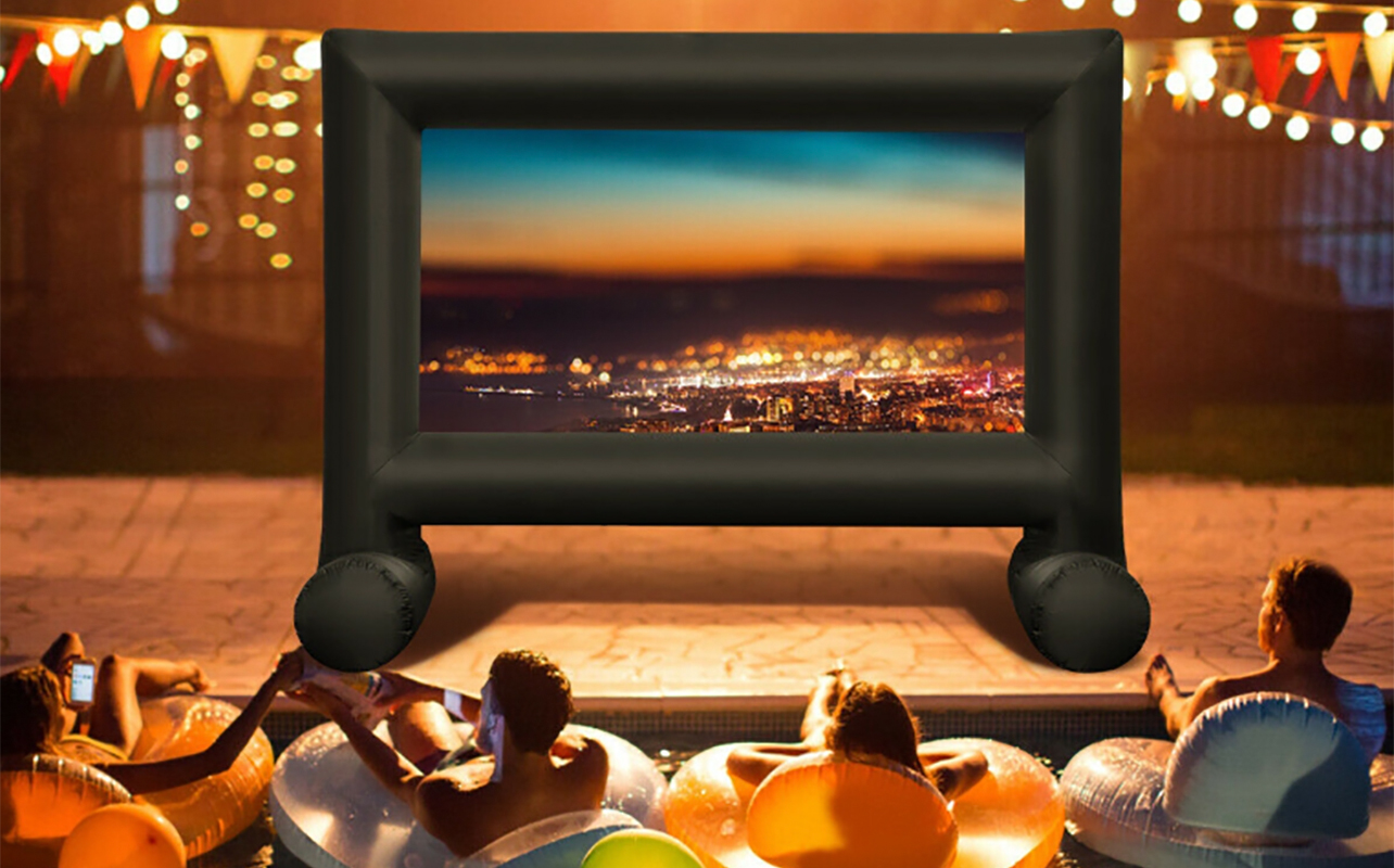 People watching a movie outside with an inflatable projector screen.