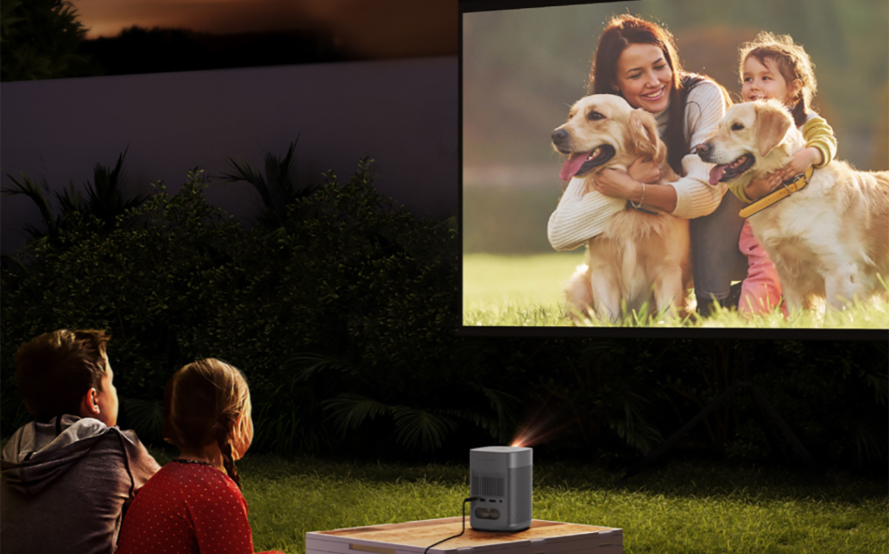 Kids watching a movie outside with an Xgimi outdoor projector.