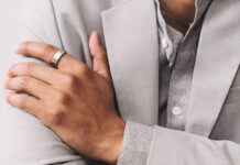 A man's hand folded over his chest wearing the Oura Ring 3.