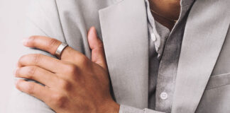 A man's hand folded over his chest wearing the Oura Ring 3.