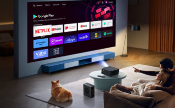 A family watching TV using the Yaber K2S projector.