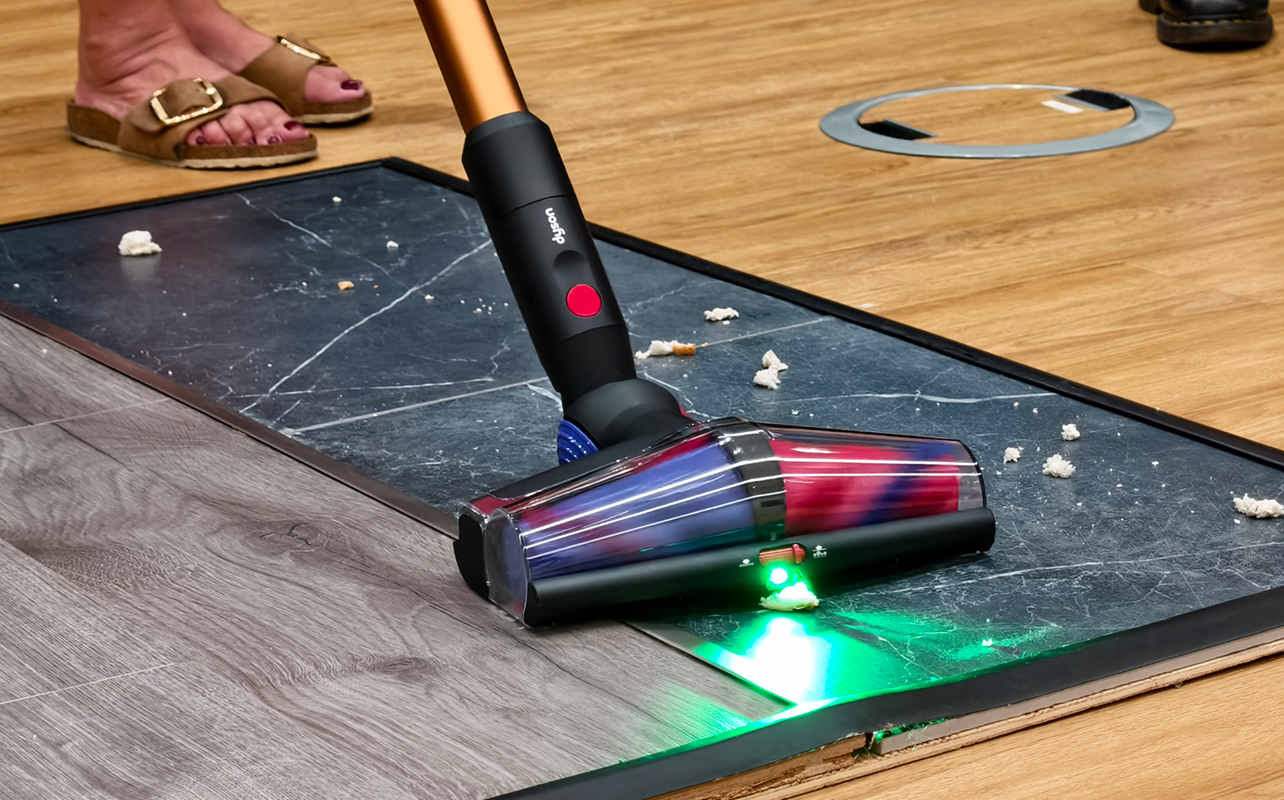 Dyson V16 Piston Animal vacuum with green laser light on floorhead.