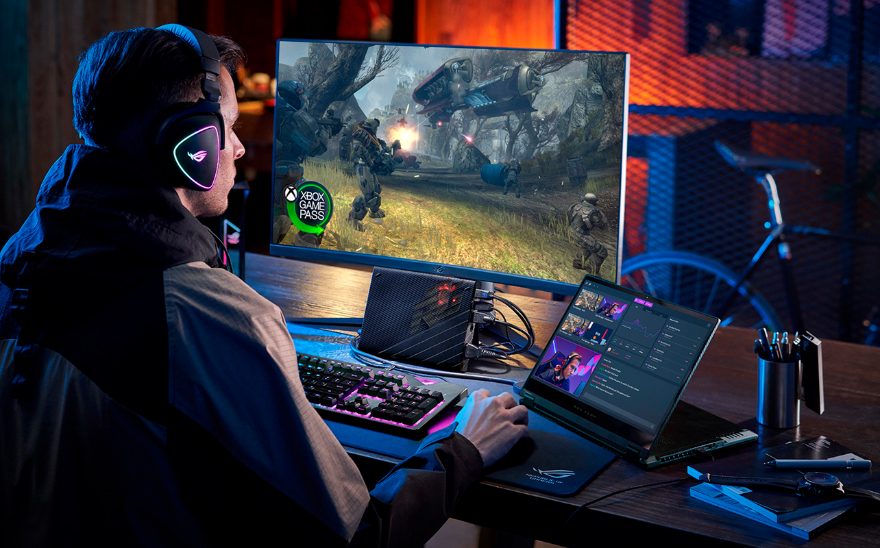 Man playing a video game on a monitor wearing headphones.