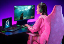 Woman playing a video game on a monitor wearing headphones.