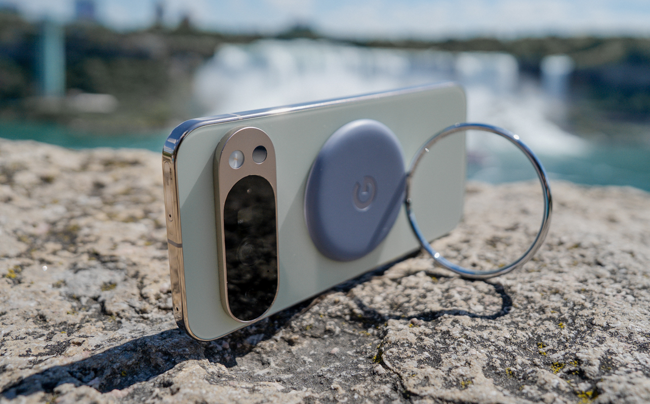 Google Pixel 10 Pro XL propped up with Pixel Ring Stand on a rocky surface.