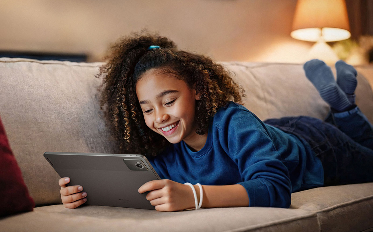 Girl smiling while using a lenovo tablet