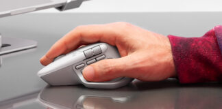 Man's right hand holding onto Ligtech MX Master 4 mouse