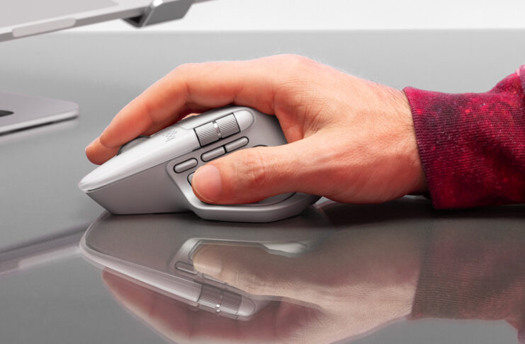 Man's right hand holding onto Ligtech MX Master 4 mouse