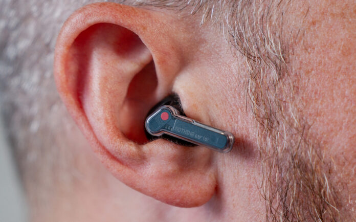 Close-up view of Nothing Ear (a) earbud in left ear.