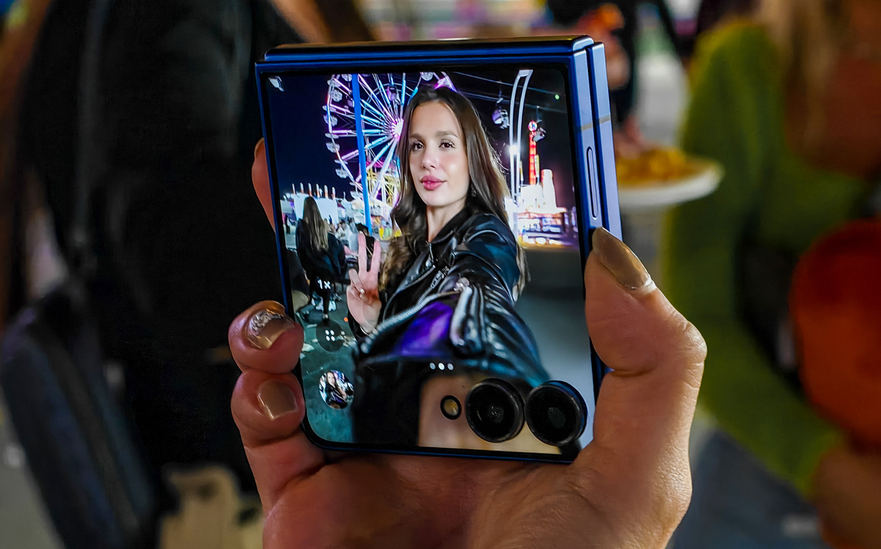 Woman taking a selfie on the Samsung Galaxy Z Flip7.