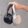 Holding the Sony WH-1000XM6 and XM5 in hand.