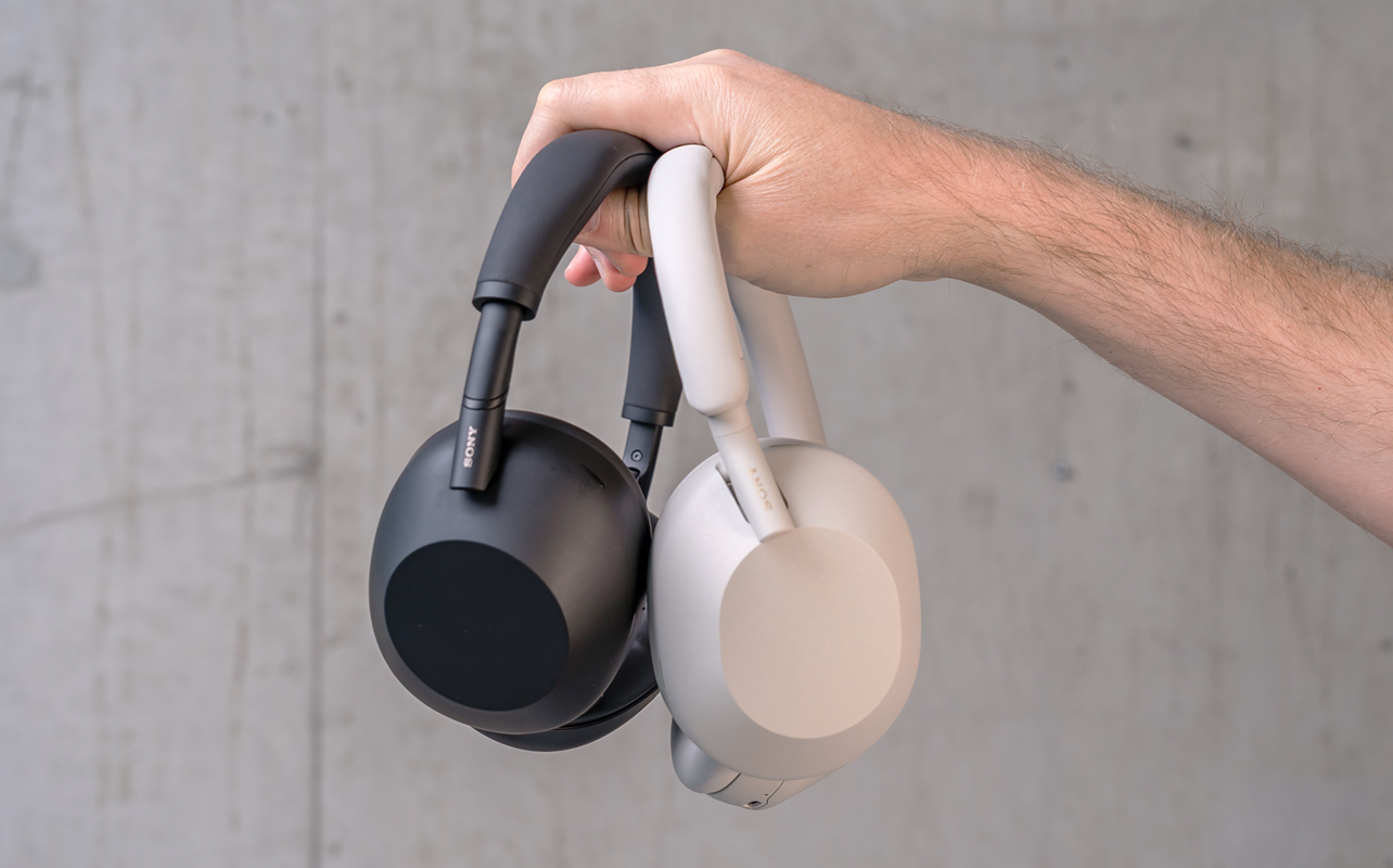 Holding the Sony WH-1000XM6 and XM5 in hand.