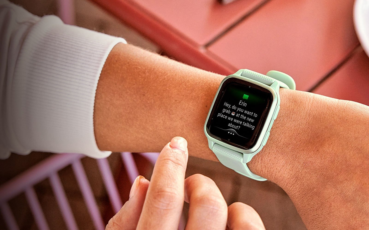 A Garmin Venu Sq2 on a wrist showing a message.