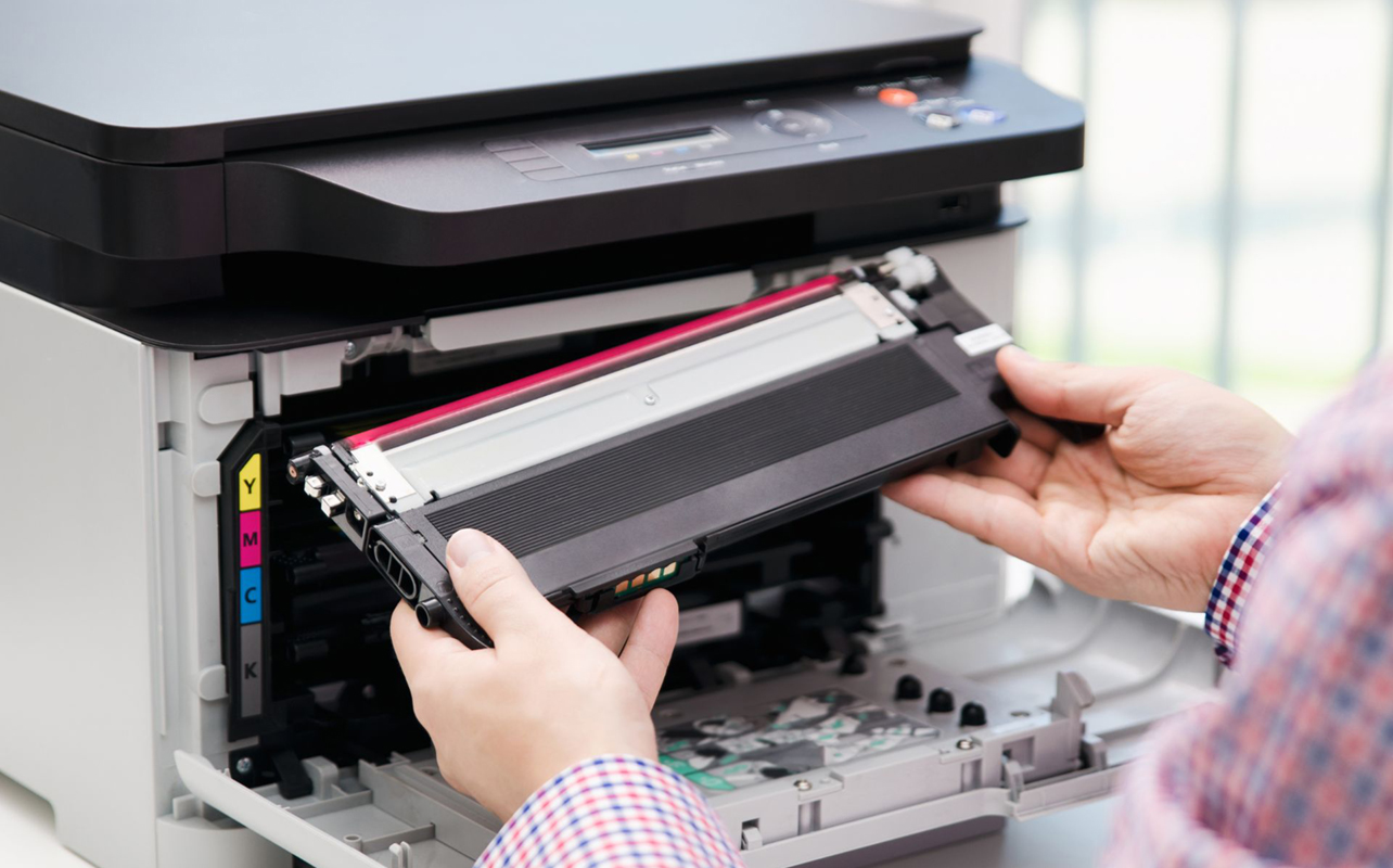 inkjet vs laser printer - Toner cartridge in front of a laser printer.