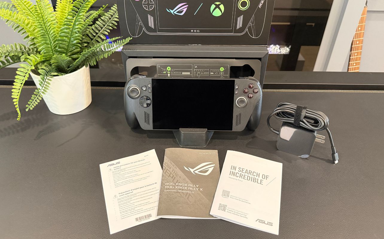 ASUS ROG Xbox Ally X with unboxed components on a desk.