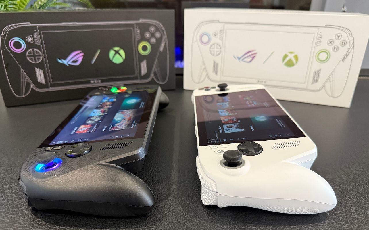 A side view of the ASUS ROG Xbox Ally and the ASUS ROG Xbox Ally X sit side by side in front of their retail boxes.
