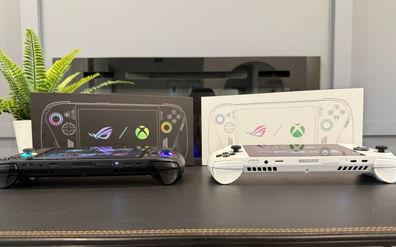 A view of the ASUS ROG Xbox Ally and the ASUS ROG Xbox Ally X laid on a desk with their ports in view.