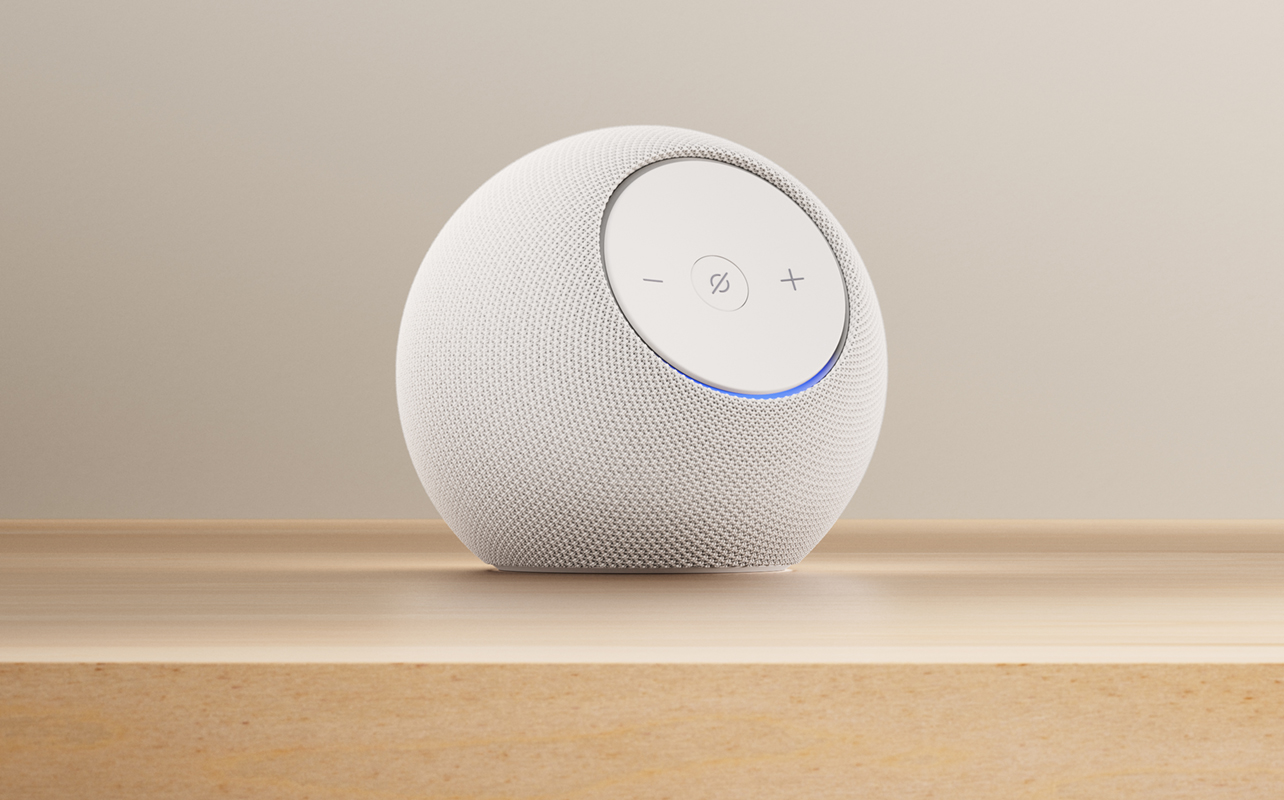 Amazon Echo Dot Max in glacier white on wooden table.
