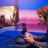 Man playing on a PlayStation 5 wearing a gaming headset.