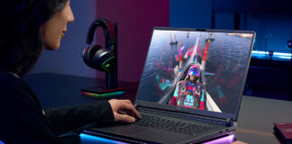 Woman playing video games on a gaming laptop.