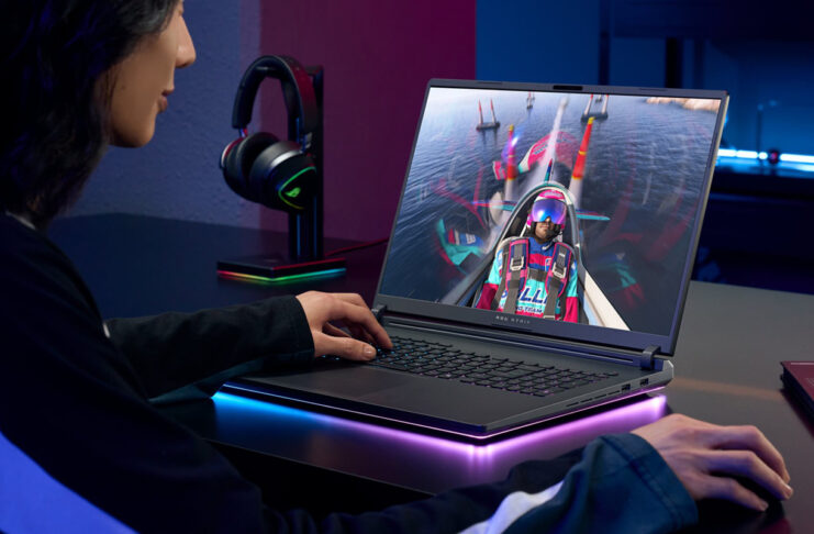 Woman playing video games on a gaming laptop.
