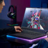 Woman playing video games on a gaming laptop.