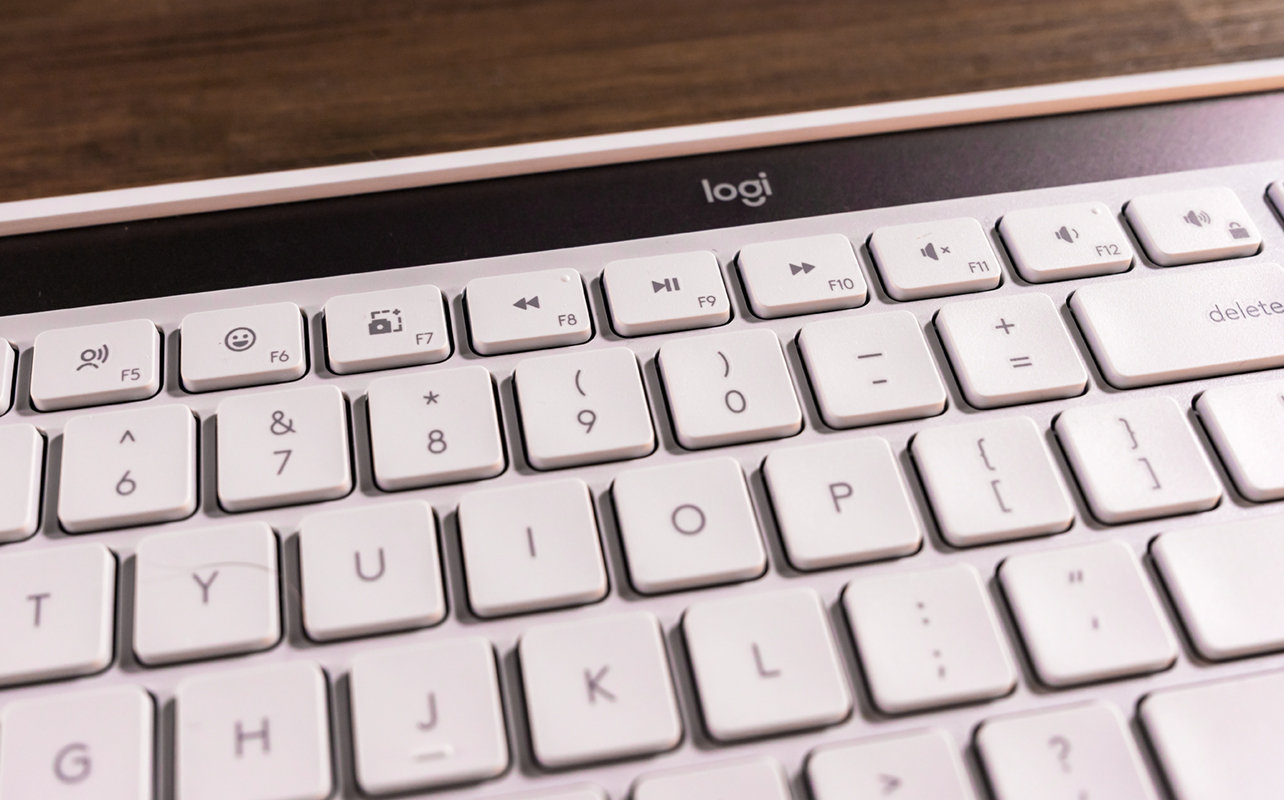 Logitech Signature Slim Solar+ K980 keyboard with panel and keys visible.