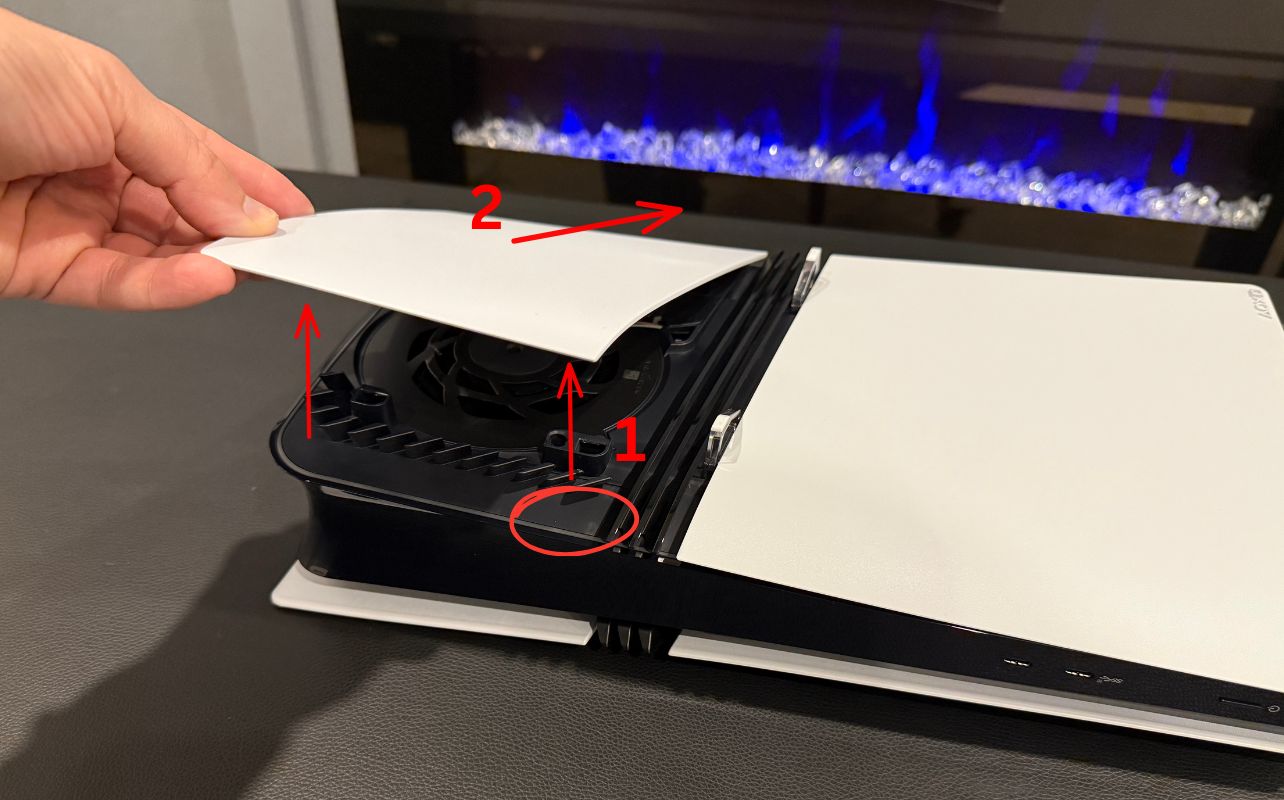 A picture with red lines indicating the steps to remove the access panels on the PS5 Pro gaming console.