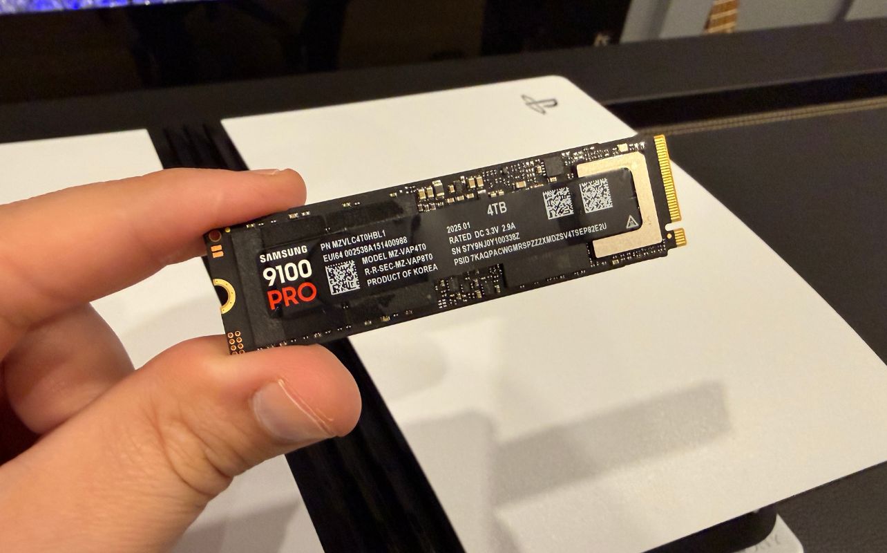 The Samsung 9100 Pro SSD is in front of the PS5 Pro gaming console, which is laid out vertically.