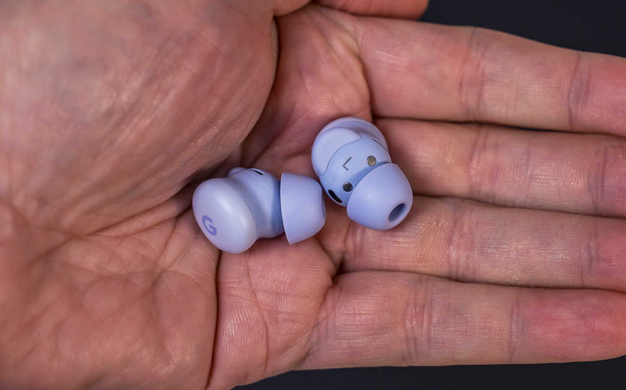Google Pixel Buds 2a loose in palm of hand.