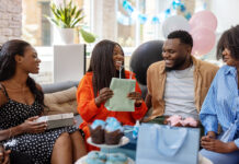 They just had a baby—here are 10 gifts they really need Smiling pregnant woman getting presents at baby shower. Happy mother to be receiving gifts from friends at baby shower party.