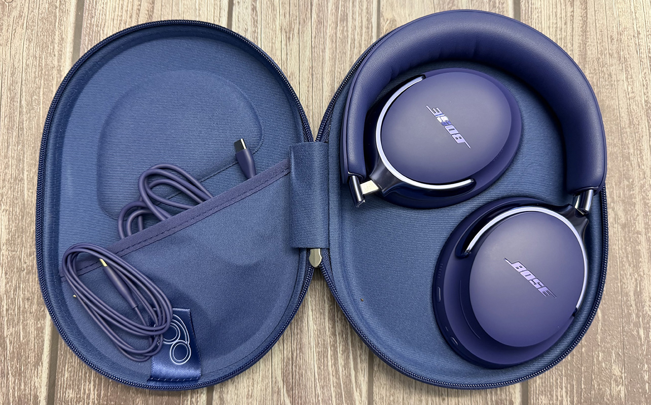Bose QuietComfort Ultra 2nd Gen headphones in the case open with cables.