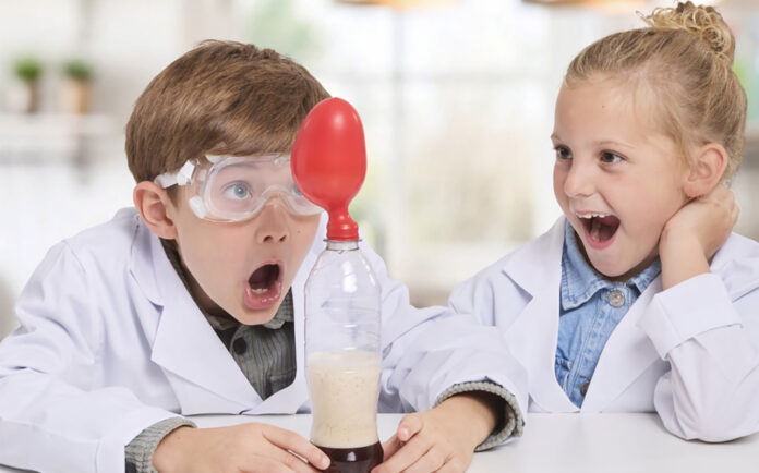 LEGO, games, and more: Top holiday gifts for kids of all ages Two kids playing with the Brainstorm Chemistry Kit.