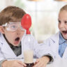 Two kids playing with the Brainstorm Chemistry Kit.