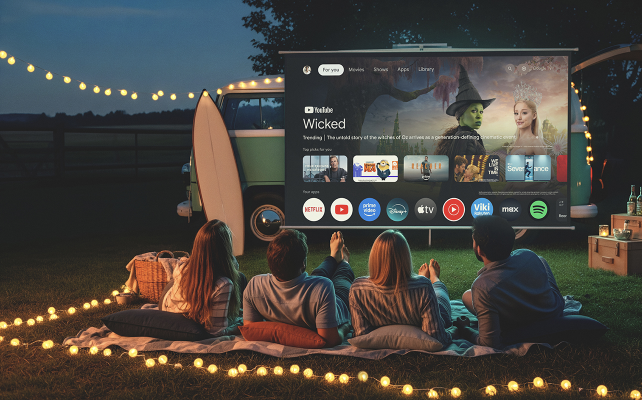 Aa family watching a movie outside using an Epson projector.