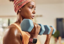 A woman training with a smartwatch on her wrist