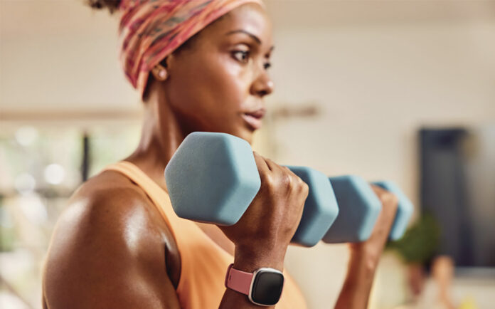 A woman training with a smartwatch on her wrist