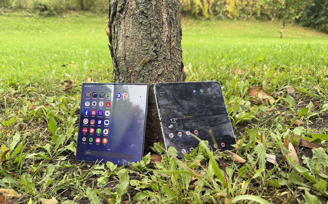 Galaxy Z Fold 7 and Pixel 10 Pro Fold both unfolded leaning against a tree.