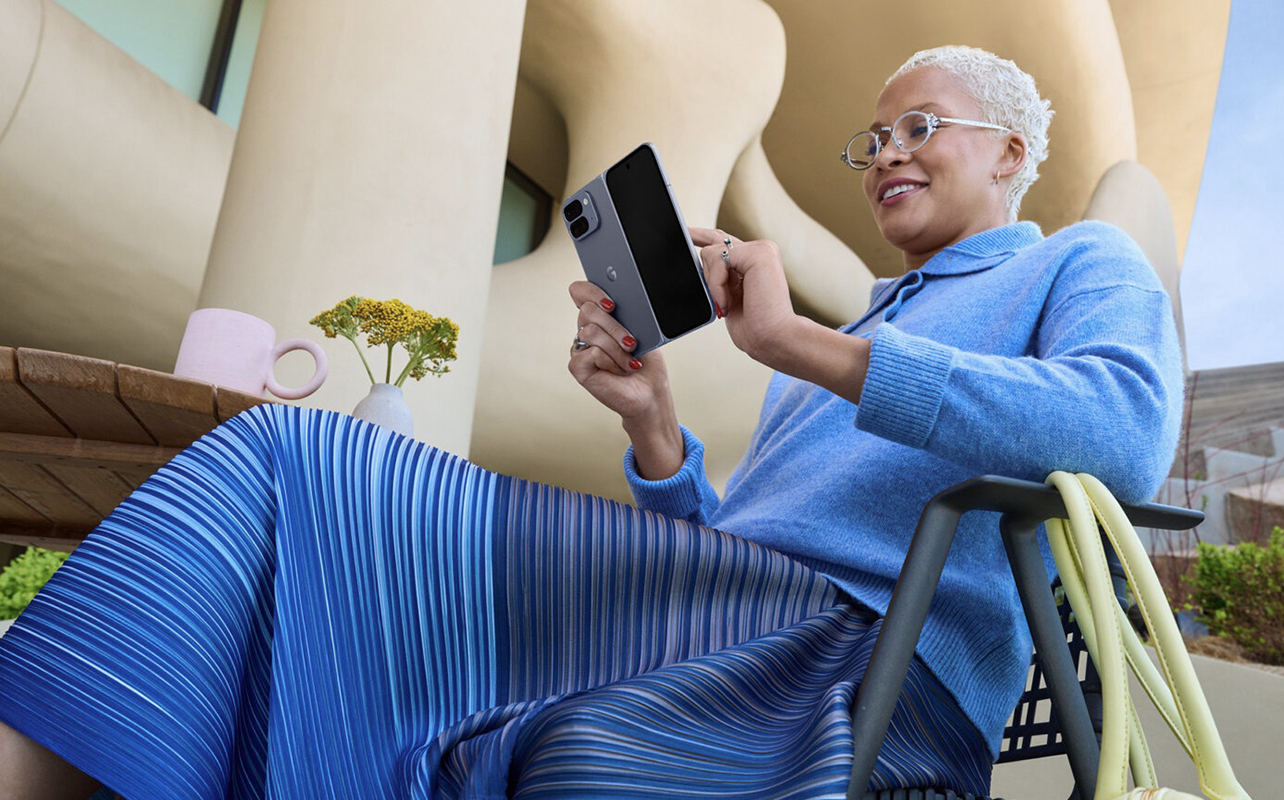 A woman sitting back using the Google Pixel 10 Pro Fold