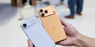 A hand holding the iPhone Air and iPhone 17 Pro in an Apple Store.