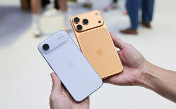 A hand holding the iPhone Air and iPhone 17 Pro in an Apple Store.