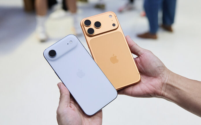 iPhone 17 series phones: which one should you get? A hand holding the iPhone Air and iPhone 17 Pro in an Apple Store.