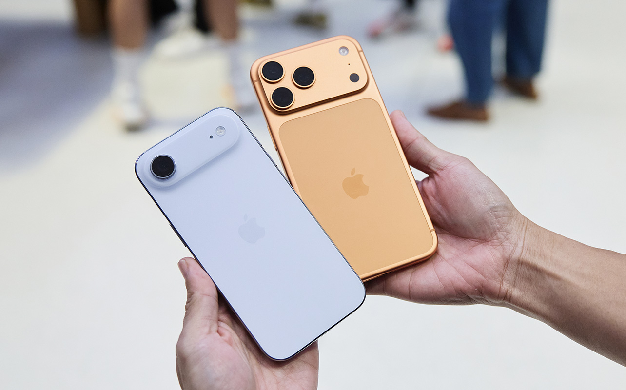A hand holding the iPhone Air and iPhone 17 Pro in an Apple Store.